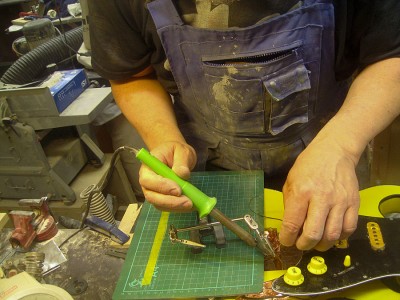 Soldering the pickguard to the output jack and the grounds.