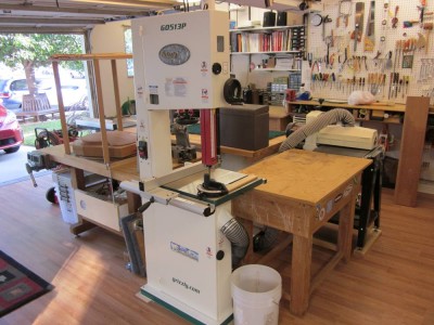 Here is the bandsaw, sander and their outfeed table from the other direction. You can see out the garage door and also see the window above the finish table.