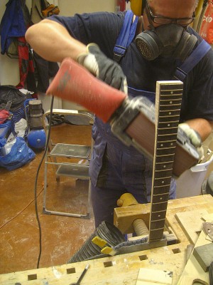 I'm not good friends with spokehaves, so I shape my necks with different sanders. I start out with a belt sander...