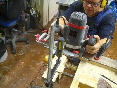 I started with making the fretboard. I bought a board of walnut and cut some fretboard blanks out of it, planed them and took one for this project. The first thing was to route the nut slot using a T-shaped guide I've made. It may look like there are two different guys building this guitar, because I've grown a beard since I started the project. The camera data says the picture was taken in April 2010, but i't calendar has been off by two years. This shot was taken a little over a year ago and the camera's date setting should be correct now.