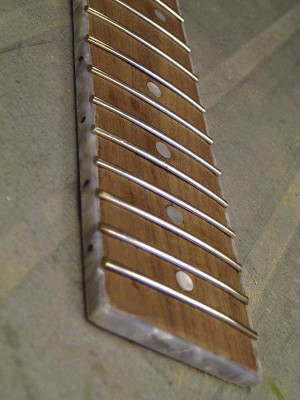 Here's the fretboard with binding. It took me a while to level the frets, but now they're good.