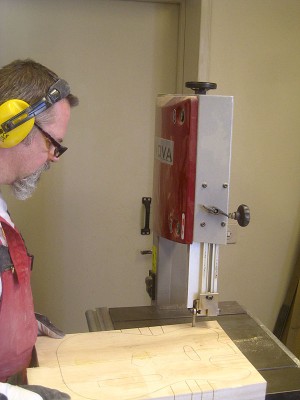 Cutting out the body with a bandsaw. I have purchased good plans of the Telecaster and made a plywood template for the body. Here's the new guy at work.