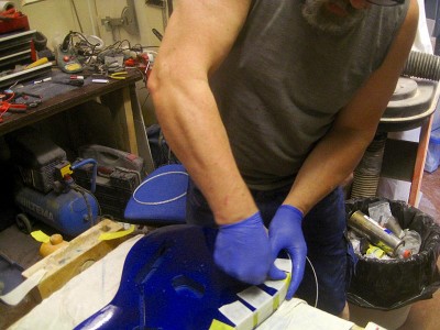 Fixing the binding into its channel with masking tape until the adhesive has set.