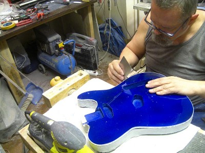 Scraping the binding flush with the body.