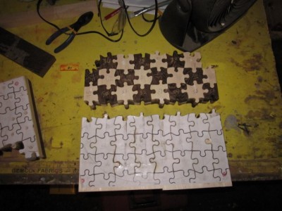 Cutting the puzzle pieces from stacked maple and wenge.