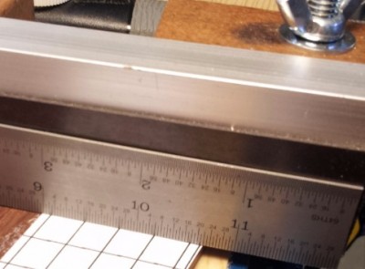 A straightedge is placed on the magnetic strip, and the workpiece adjusted to match the fret marker line with the straightedge.  &gt;Be very consistent about how they are aligned to each other.&lt;