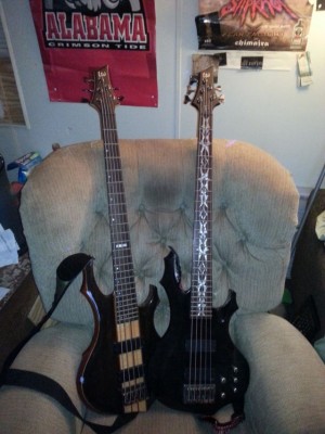 The 2 bass guitars in question. The new one is the darker one with the tribal inlays, which I love, on the right.